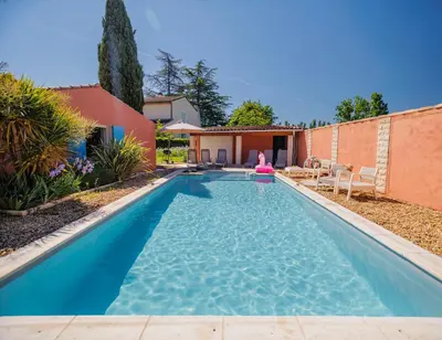 a swimming pool in the backyard of a house at Villa provençale avec piscine privée et jardin ensoleillé in Mollégès