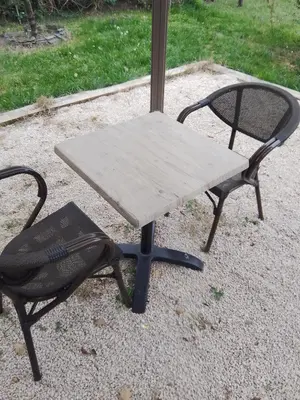 a picnic table and a chair on the ground at Le passé temps in Éguilles