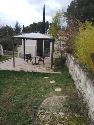 a gazebo with a table and a bench at Le passé temps in Éguilles
