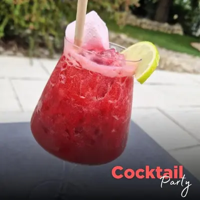 a red drink with a lime and a straw at Gîte Le Provence Spacieux 100m2 in Saumane-de-Vaucluse