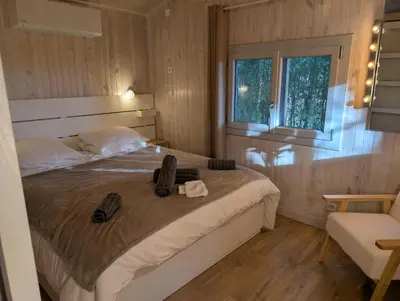 a bedroom with a bed with shoes on it at Le Chalet Bleu - jacuzzi in Aix-en-Provence