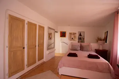a bedroom with a large bed in a room at Maison Valabregue in Robion en Luberon