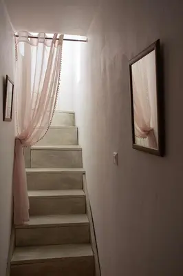 a stairway with a window and a mirror on the wall at Maison Valabregue in Robion en Luberon
