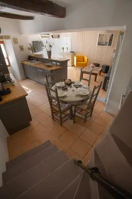 a kitchen and living room with a table and chairs at Maison Valabregue in Robion en Luberon
