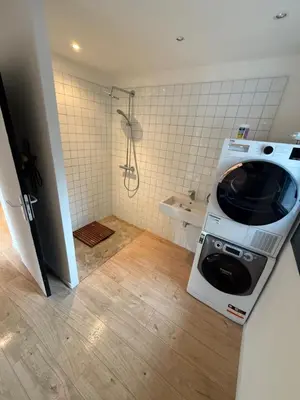 a washing machine in a bathroom with a shower at Maisonnette in Aix-en-Provence