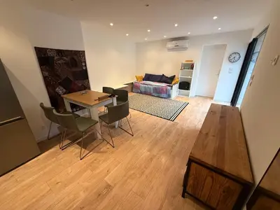 a living room with a table and chairs and a couch at Maisonnette in Aix-en-Provence