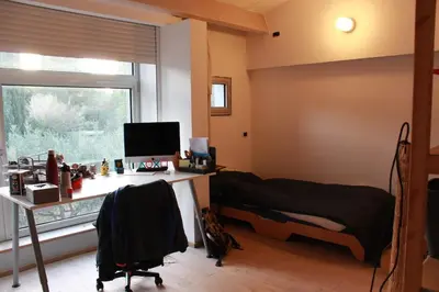 a bedroom with a desk with a computer and a window at Maison aix en Provence piscine in Aix-en-Provence