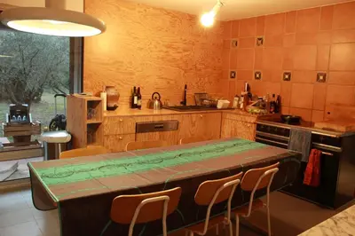 a kitchen with a table and some chairs in it at Maison aix en Provence piscine in Aix-en-Provence