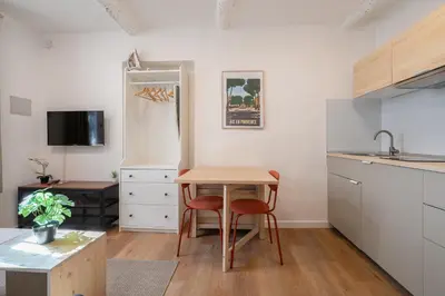 a kitchen with white cabinets and a microwave at Studio Climatisé rdc plein centre in Aix-en-Provence