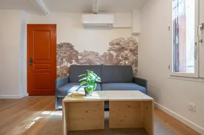 a living room with a blue couch and a coffee table at Studio Climatisé rdc plein centre in Aix-en-Provence