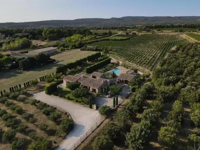 an external view of a house with a swimming pool at Maison de charme avec piscine chauffée à Gordes in Gordes