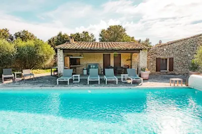an image of a swimming pool in front of a house at Maison de charme avec piscine chauffée à Gordes in Gordes