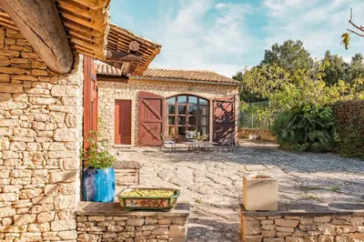 an entrance to a brick wall with a gate at Maison de charme avec piscine chauffée à Gordes in Gordes