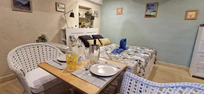 a dining room with a table and a bed at Lou pichoun studio au coeur d'un village provençal in Gargas