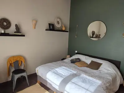 a bedroom with a bed with a mirror and a chair at Villa 170m2 avec piscine près d Aix en provence 7 couchages in Éguilles