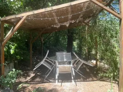 a group of chairs and a table under a pavilion at Le Charmeur - Le Chalet Attrape-Coeur in Aix-en-Provence