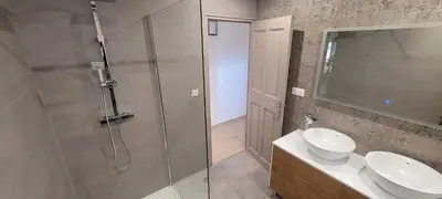a bathroom with a shower and a sink and a toilet at Charming villa with a pool in Cadenet