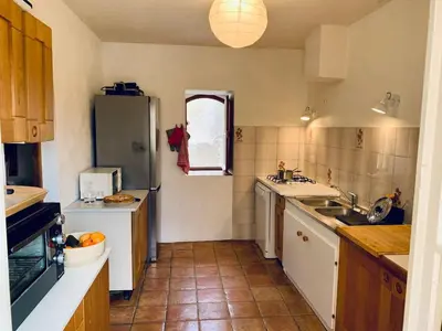 a kitchen with a sink and a refrigerator at Provencal farmhouse in Luberon's heart with pool in La Bastide-des-Jourdans