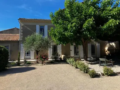 a house with a tree in front of it at MaisonAdèle in Caromb