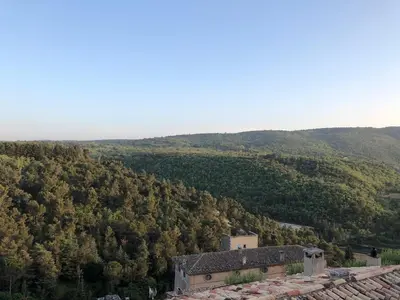 an old building in the middle of a mountain at Campanina in Bonnieux