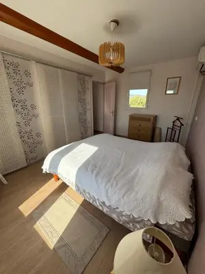 a bedroom with a bed and a window at Mas de charme provencal in Cavaillon