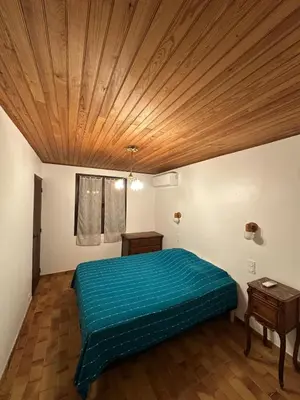 a bedroom with a bed and a wooden ceiling at Maison Provençale Vue Étang & Charme Médiéval in Saint-Chamas