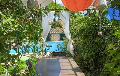 a garden with a swimming pool and a house at Awesome Apartment In Carpentras in Carpentras