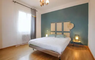 a bedroom with a bed and a green wall at Awesome Apartment In Carpentras in Carpentras