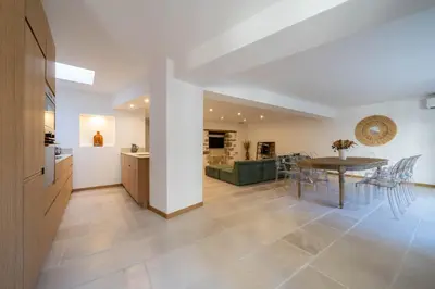 a kitchen and dining room with a table and chairs at Exceptionnel - Couvent entièrement rénové - classé Patrimoine - Piscine, au calme et à 100 m du coeur de l'Isle in LʼIsle-sur-la-Sorgue