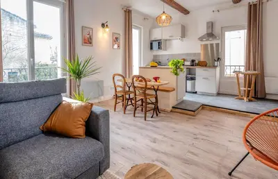 a living room with a couch and a table at Charmant Appartement au Cœur du Village de Bedoin in Bédoin