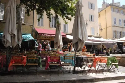 a group of tables and chairs with umbrellas at Gorgeous! heart of Aix en Provence appartement climatisé in Aix-en-Provence