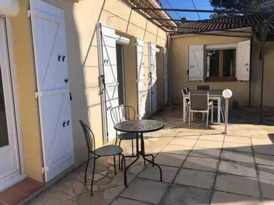 a patio with a table and chairs and a dining room at Maison provençale familiale avec piscine - 6 personnes in Lambesc