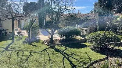 a garden with trees and bushes in a yard at Maison provençale familiale avec piscine - 6 personnes in Lambesc
