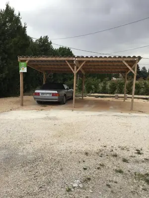 a car parked under a wooden pavilion at Gites victoria in Cavaillon