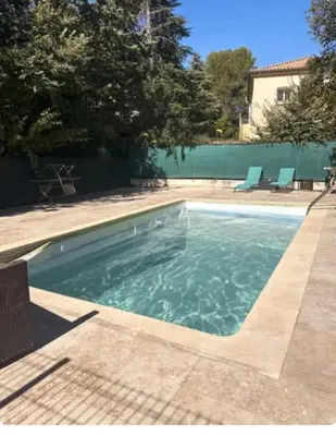 a swimming pool with water in a yard at Le Clos d'Aix Célony studio 9 parking in Aix-en-Provence