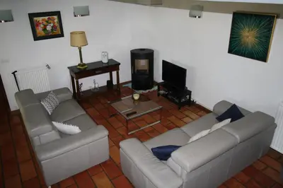 a living room with two couches and a television at Villa avec piscine dans le Luberon in La Tour-dʼAigues