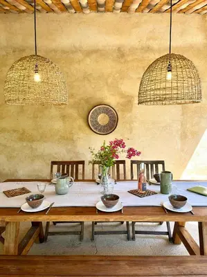 a wooden table with two chairs and two lights at Bright Villa In The Heart Of Luberon in Céreste
