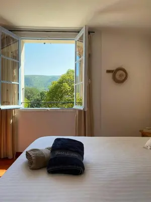 a bedroom with a door leading to a patio at Historic Bastide With Private Pool In The Luberon in Céreste