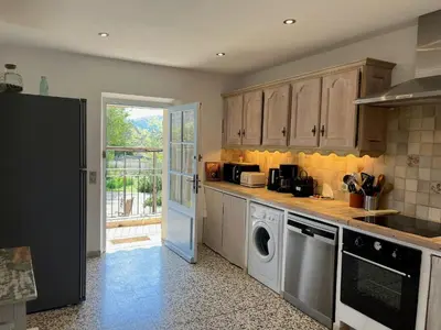 a kitchen with a washer and dryer in it at Historic Bastide With Private Pool In The Luberon in Céreste