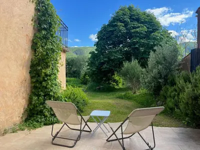 two chairs and a table on a patio at Historic Bastide With Private Pool In The Luberon in Céreste