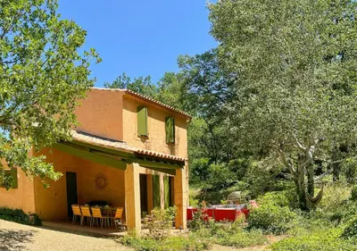 an orange house with a table and chairs outside at Peaceful Retreat In The Heart Of Luberon in Roussillon