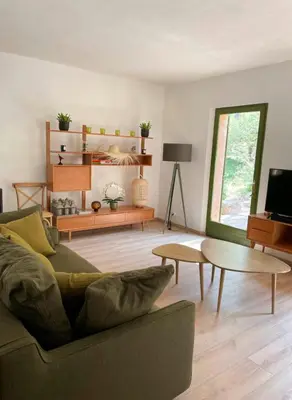 a living room with a couch and a table at Peaceful Retreat In The Heart Of Luberon in Roussillon
