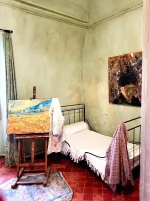 a room with two beds and a table in it at Appartement de charme au pied du château in Châteaurenard