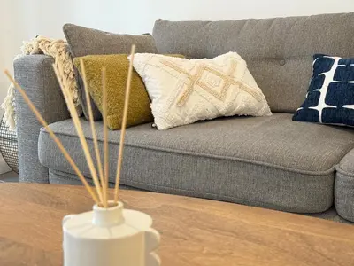 a living room with a couch and pillows at Chic et Cosy, Hyper centre in Aix-en-Provence