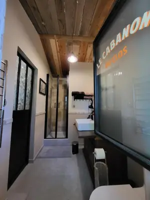 a hallway with a large tv in a room at le cabanon du clos in LʼIsle-sur-la-Sorgue