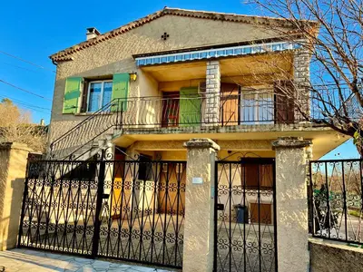 a house with a wrought iron fence in front of it at Grand Appartement Provençal in Manosque