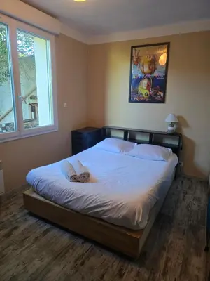 a bedroom with a bed with white sheets and a window at Maison Climatisée, Jardin, Piscine, 7 pers in Salon-de-Provence