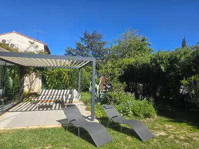 a group of chairs sitting in a yard at Maison Climatisée, Jardin, Piscine, 7 pers in Salon-de-Provence