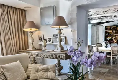 a living room with two lamps and a table with purple flowers at Character House In The Heart Of Gordes in Gordes