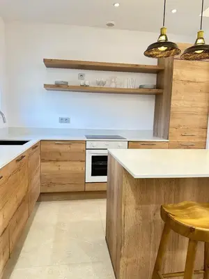 a kitchen with wooden cabinets and a counter top at Le Grand Bouteillan in Pierrevert